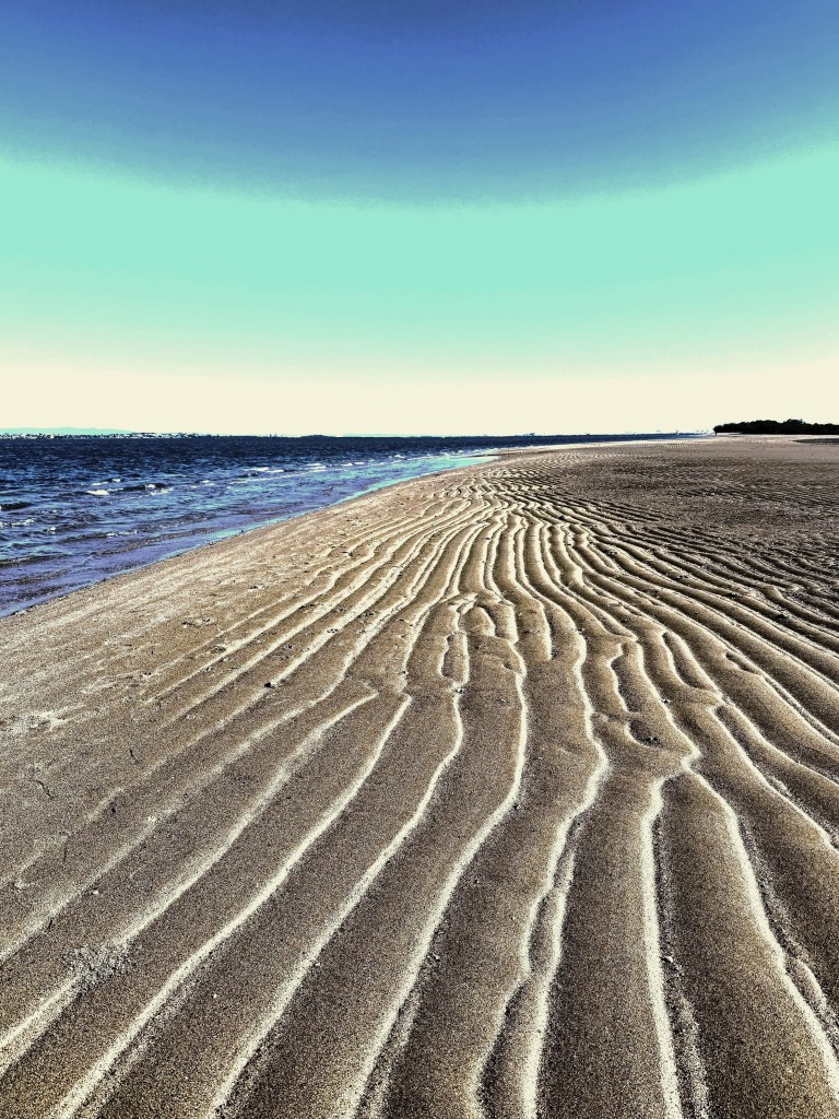 Ripples of sand on a beach.